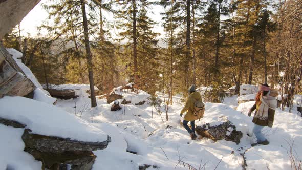 Friends Walking Down Snowy Hill