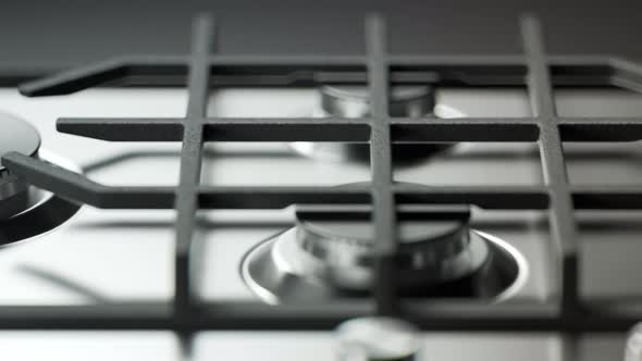 Clean, metal gas cooktop arranged in an endless pattern. Looping animation. 4KHD