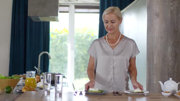 Wealthy Caucasian Lady Preparing Breakfast for Two at Home