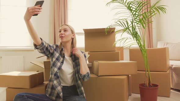 The Woman Took a Break and Communicates Via Video Link Using a Smartphone