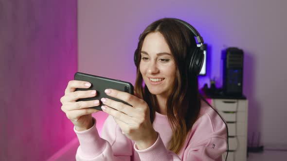 Woman Play Game with Smartphone Female Wining and Show Gesture Yes