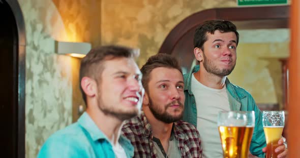 Closeup to the Camera Charismatic Good Looking Guys in a Pub Watching a Fav Match