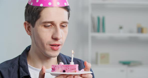 Portrait of Happy Caucasian Millennial Man Lonely Isolated Adult Young Guy in Pink Party Hat Holding