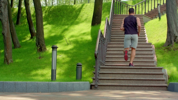 Young Man Running Upstairs In. Young Man Running Up Stairs At Park