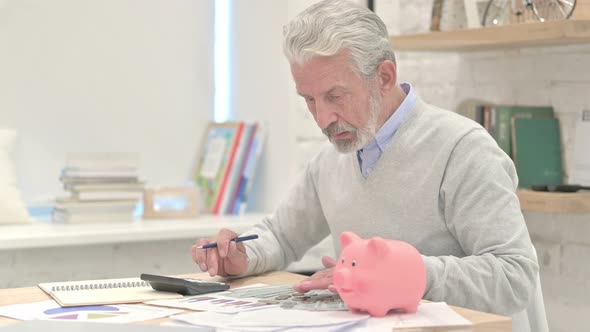 Old Man Putting Coin in Piggy Bank, Saving Money