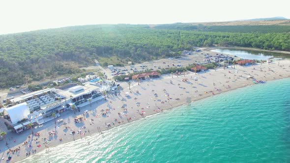 Flying above clubbing beach of Pag island in the morning