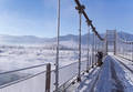 several fishermen fishing on frozen Bridge on a snowy sunny day - PhotoDune Item for Sale