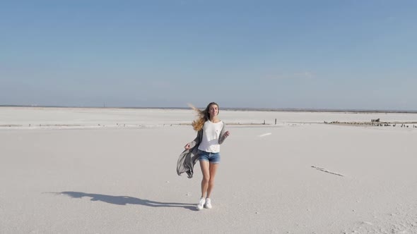 Happy Woman on White Salt Lake on Sunny Summer Day