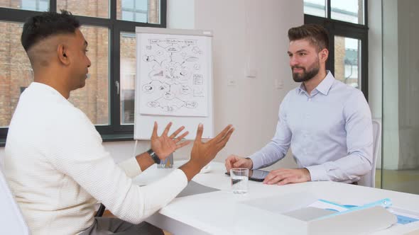 Employer Having Interview with Employee at Office 