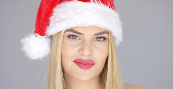 Portrait Of Beautiful Blond Girl In Santa Claus Hat