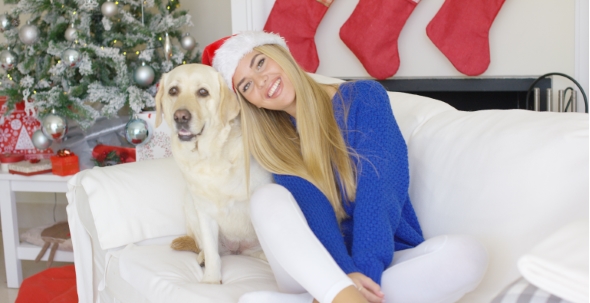 Christmas Girl With Her Dog Friend At The Couch