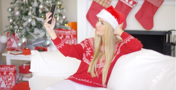 Sexy Blond Girl In Christmas Outfin Taking a Selfie