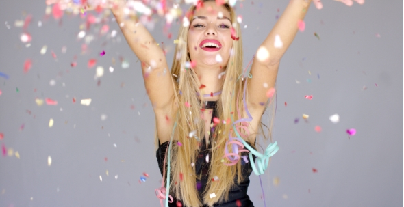Sexy, Blond Girl Blowing Confetti To Camera Direction