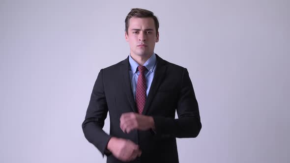 Young Handsome Businessman Wearing Suit with Arms Crossed