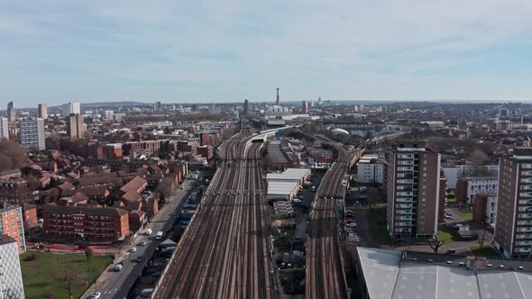 Drone shot over train tracks leaving London in Southwark