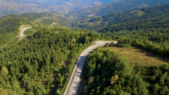 steep green mountains, deep forest and mountain road, beautiful valley  