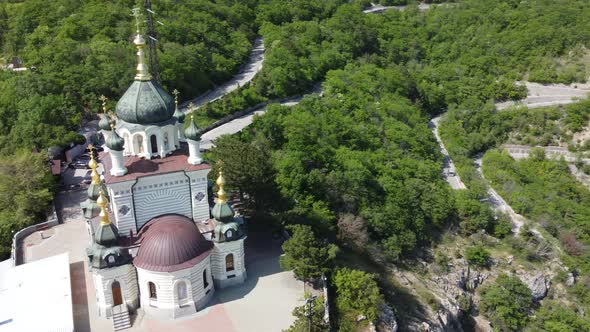 Aerial View of Foros Church and Mount Road Through the Spring Forest