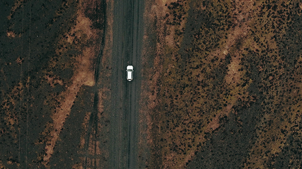 Car Driving Along Dirt Road