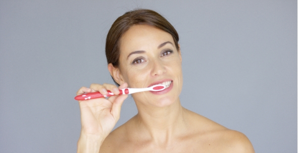 Healthy Young Woman Cleaning Her Teeth