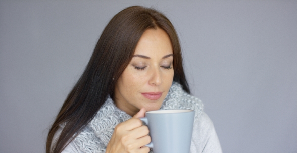 Beautiful Brunette Woman With a Cup Of Hot Drink