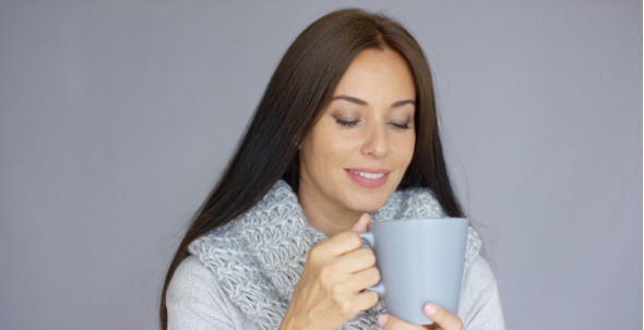 Beautiful Brunette Woman With a Cup Of Hot Drink