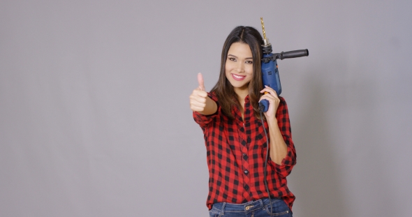 Capable Young Woman Holding a Power Drill