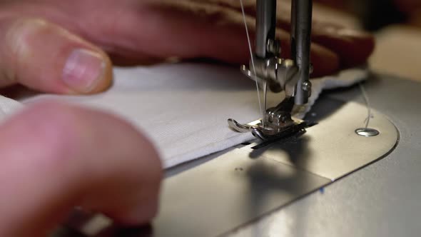 Tailor at Sewing Machine Sews a Homemade Medical Face Mask To Protect Covid-19