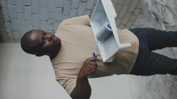 Vertical Portrait of African-American Man with Paint Roller