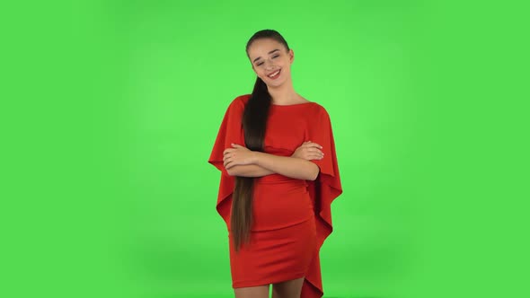 Pretty Young Woman Communicates with Someone in a Friendly Manner. Green Screen