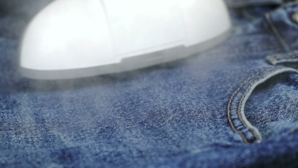 Woman Soars The Jeans Using The Steam Cleaner