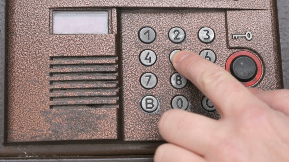 Hand Dials Number Of Apartment On Intercom System