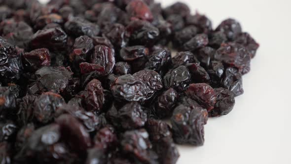 Tilting over sweetened and  dehydrated cranberries 4K 2160p 30fps UltraHD footage - Pile of Vacciniu