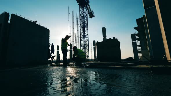 Backlit Building Workers Are Assemblying Carcasses alt