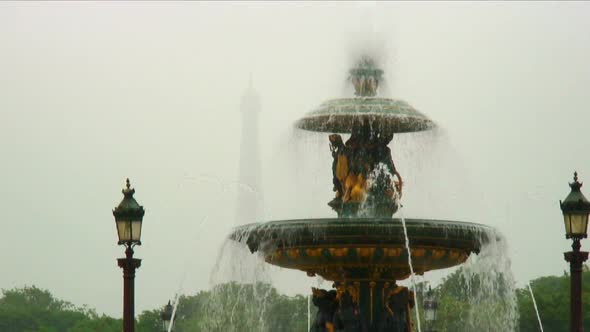 Shot of a fountain with a silhouetted Eiffel Tower in the background.