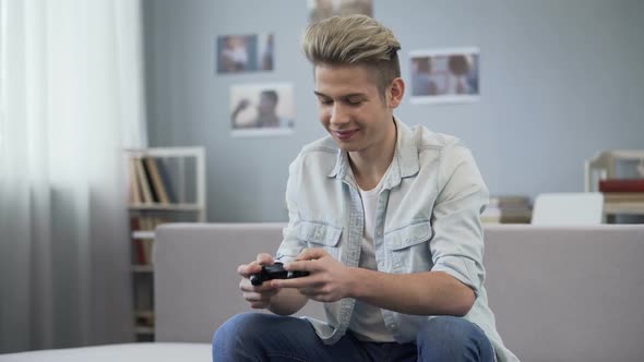 Guy Actively Pressing Joystick Buttons Finishing Video Game Round, Addiction