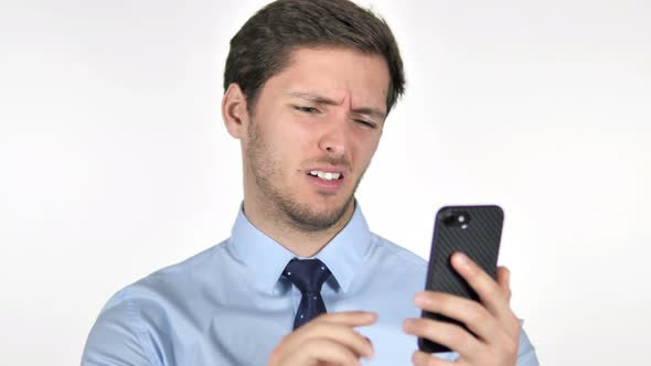 Young Businessman Reacting to Loss on Smartphone on White Background