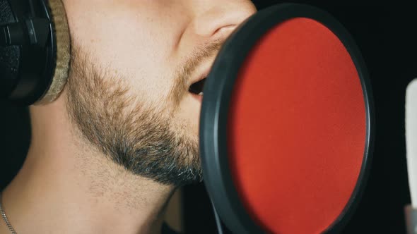 Mouth of Male Singer Singing in Sound Studio