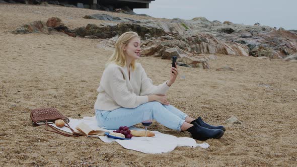 Woman Has Online Call On Beach