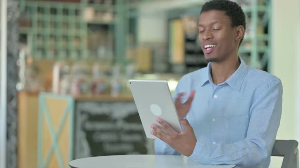 Cheerful Young African Man Doing Video Chat on Tablet