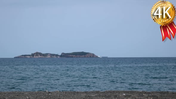 Cargo Transport Ship and Islands on Sea Horizon