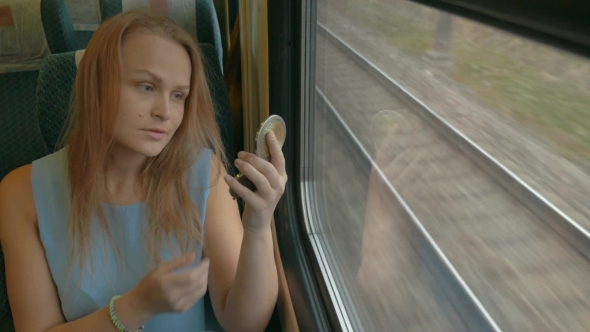 Woman With Pocket-Glass In Train
