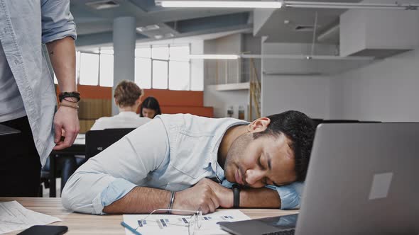 Indian Employee Fell Asleep on Work Desk His Colleague is Coming Up to Him Waking Him Up Giving