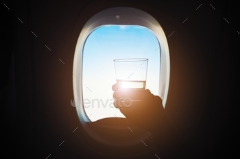 lding glass of the wine during the flight.