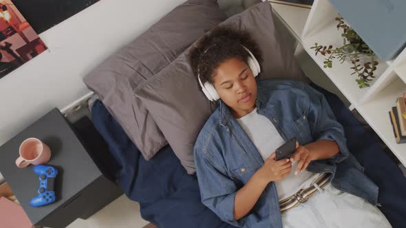 Girl Listening to Music in Bed