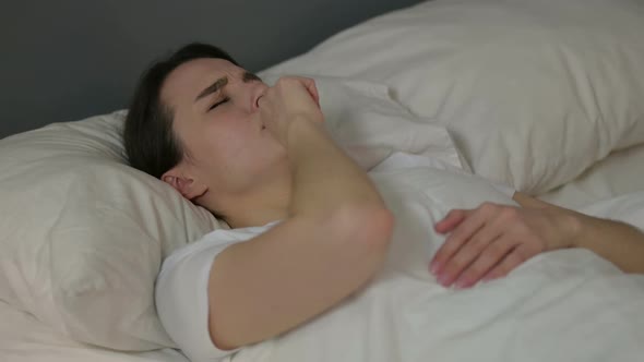 Young Woman with Cough Laying in Bed Flu