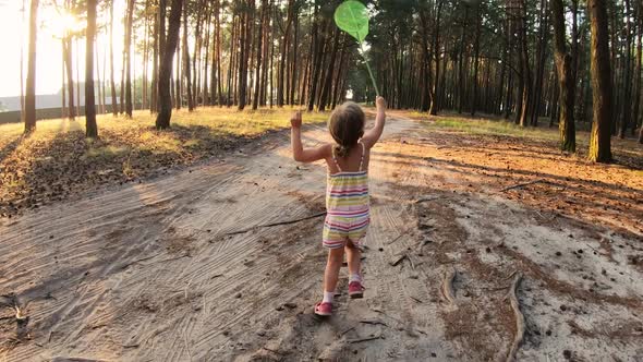 Happy Child Running and Having Fun in Forest at Sunset