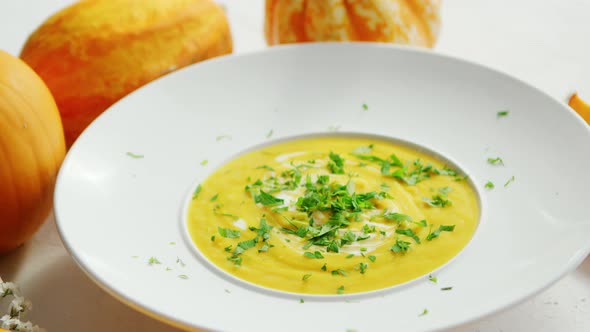 Soup in Plate with Pumpkins Around