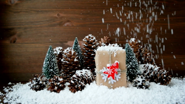 Christmas And New Year Background With Snow, Pine Cones, Present With Red Fir Tree.