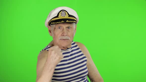 Elderly Sailor Man Is Angry and Shows a Fist. Sailorman on Chroma Key Background