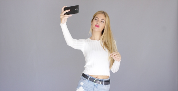 Sexy Young Blond Woman Posing For a Selfie